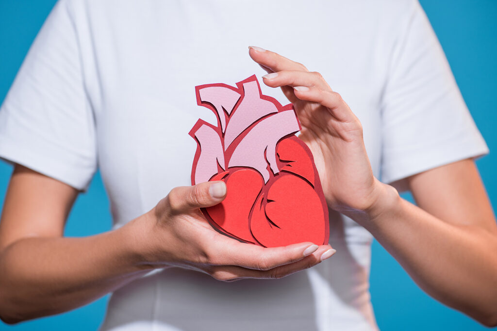 cropped shot of woman in white tshirt holding paper made heart o zupa